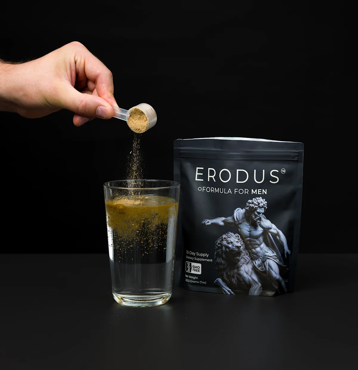 Erodus Formula for Men pouch beside a glass of water with a scoop of powder being poured in